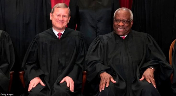 Chief Justice Roberts and Justice Thomas in black robes seat
