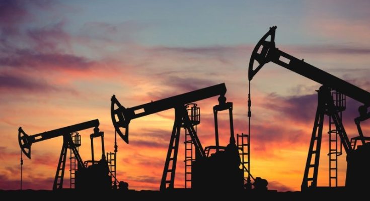 Alaska oil drilling pumps at sunset