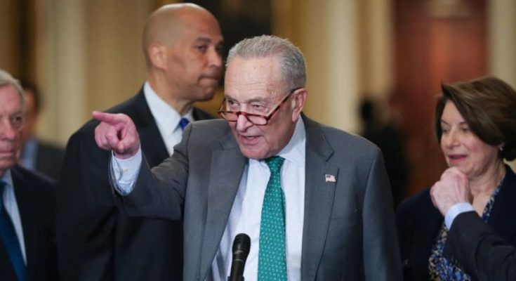 Chuck Schumer points while speaking