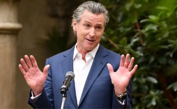 Gavin Newsom speaking with hands raised