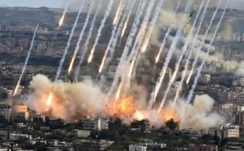 multiple rocket launchers firing simultaneously over a densely populated city, with thick