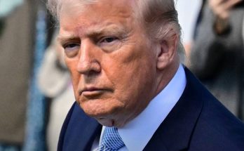former President Donald Trump in dark suit and blue tie, looking serious with text