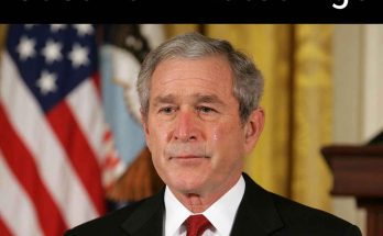 former President George W. Bush with tear on cheek during formal address, American flag