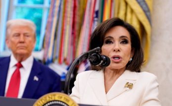 jeanine Pirro speaks at White House podium with Donald Trump standing behind her