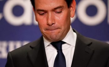 marco Rubio looking down with somber expression during campaign event