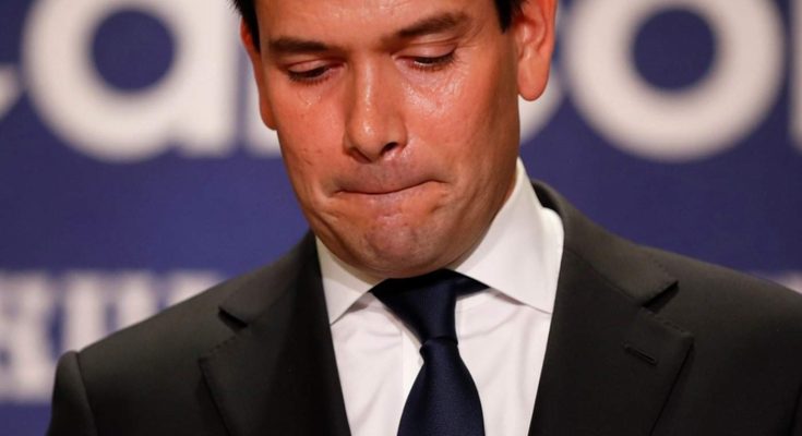 marco Rubio looking down with somber expression during campaign event