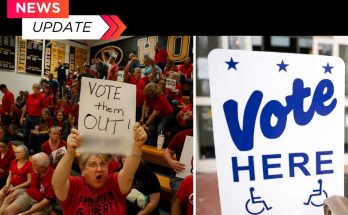 protester in red shirt holds handwritten VOTE them OUT sign beside official Vote Here