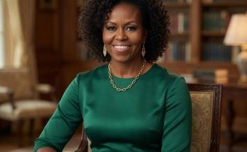 michelle Obama seated in elegant green dress with gold jewelry in stately wood-paneled