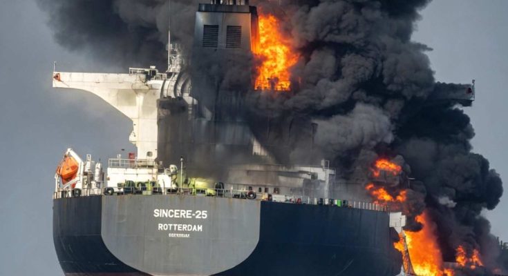 large cargo ship named SINCERE-25 Rotterdam engulfed in flames with thick black smoke