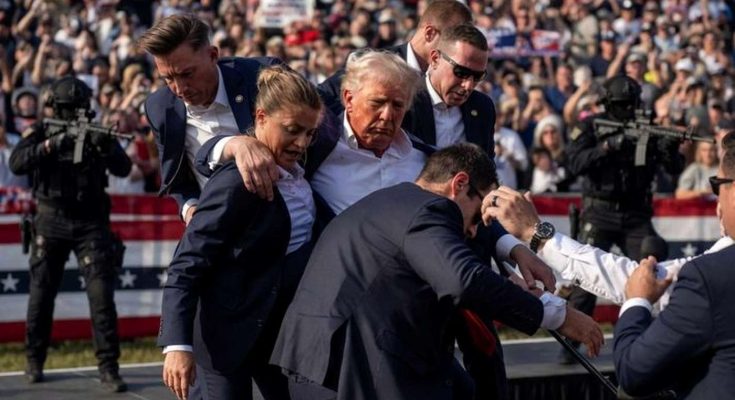 secret Service agents surround Donald Trump after assassination attempt at outdoor rally