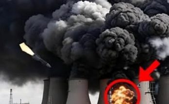 industrial cooling towers billowing black smoke with missile impact and explosion circled
