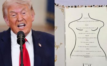 donald Trump speaking at podium beside birthday card shaped like dress form with