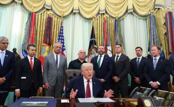 This dramatic image shows the former president speaking at a desk, surrounded by advisors in the Oval Office. He addresses the media, discussing key national issues with a backdrop of