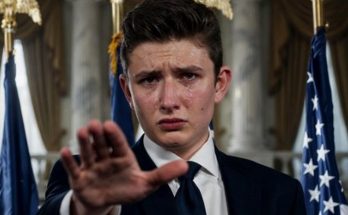 young man in dark suit crying with tears on face, hand raised in stop gesture, American