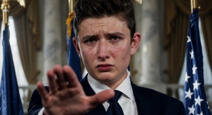 young man in dark suit crying with tears on face, hand raised in stop gesture, American