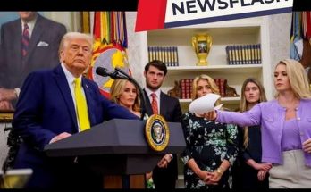 donald Trump stands at presidential podium with family members during official White