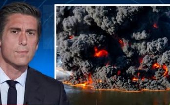 news anchor in studio with split screen showing massive industrial fire with thick black