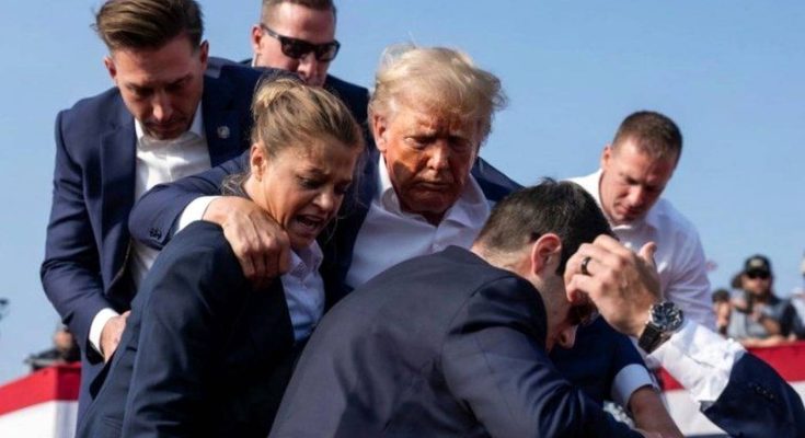 donald Trump surrounded by Secret Service agents during apparent security incident at