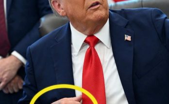 donald Trump seated at desk with visible tattoo on his right hand circled in yellow
