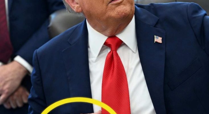donald Trump seated at desk with visible tattoo on his right hand circled in yellow