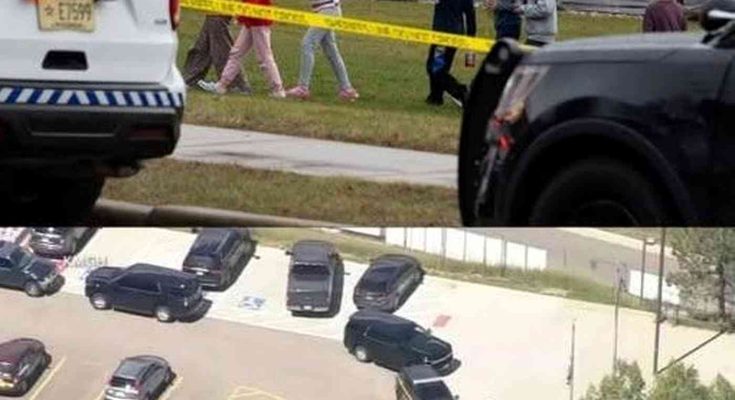children evacuate past police tape as tactical teams respond to school shooting emergency