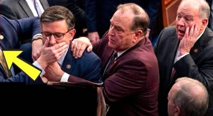congressman Mike Johnson covers his face with both hands during an emotional moment on