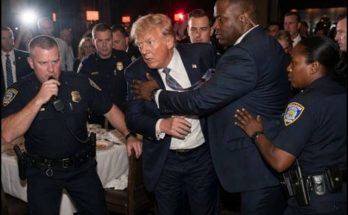 donald Trump being escorted by Secret Service and NYPD officers through crowded hotel